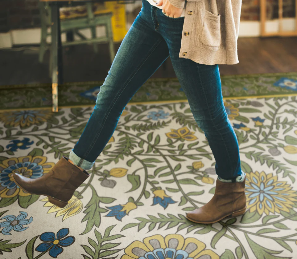 a person standing on a patterned vintage vinyl rug